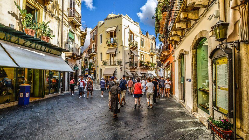 Bustling Corso Umberto in Taormina, with charming Sicilian architecture and lively atmosphere