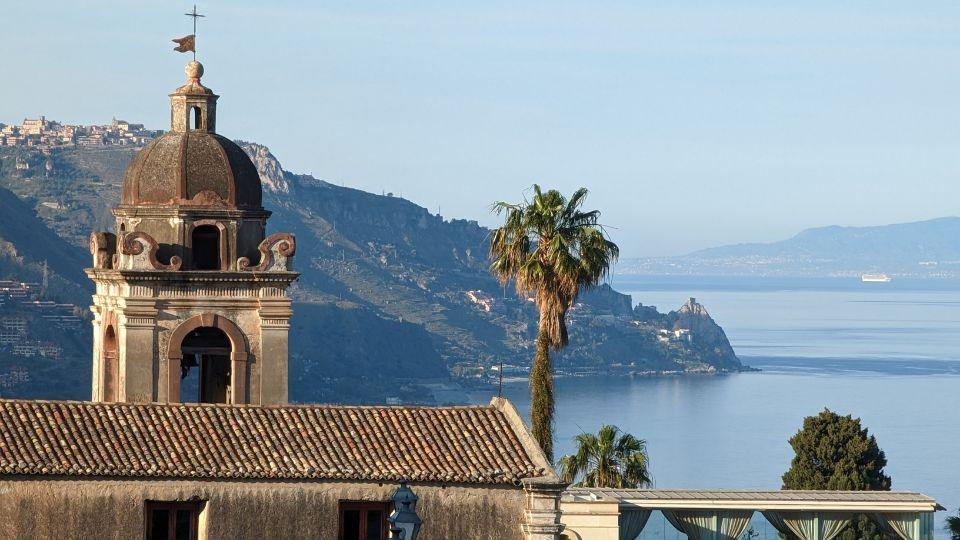 Scenic view of Taormina’s historic church tower with the Ionian Sea and mountains in the background